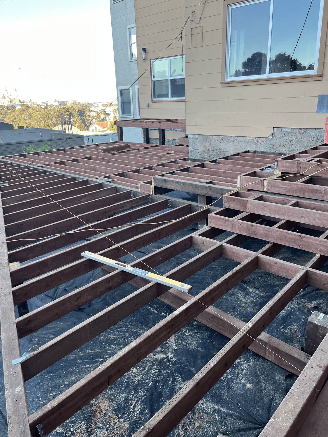Deck joists and beams framed over a prepared base