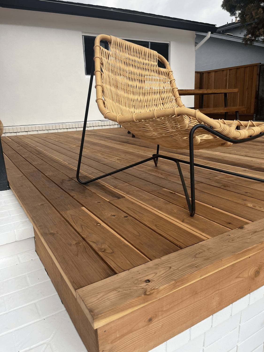 Finished redwood deck with a chair and clean board layout