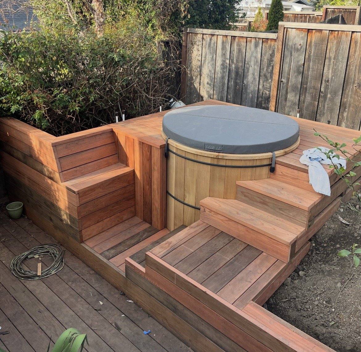 Redwood deck with built-in bench seating and hot tub surround