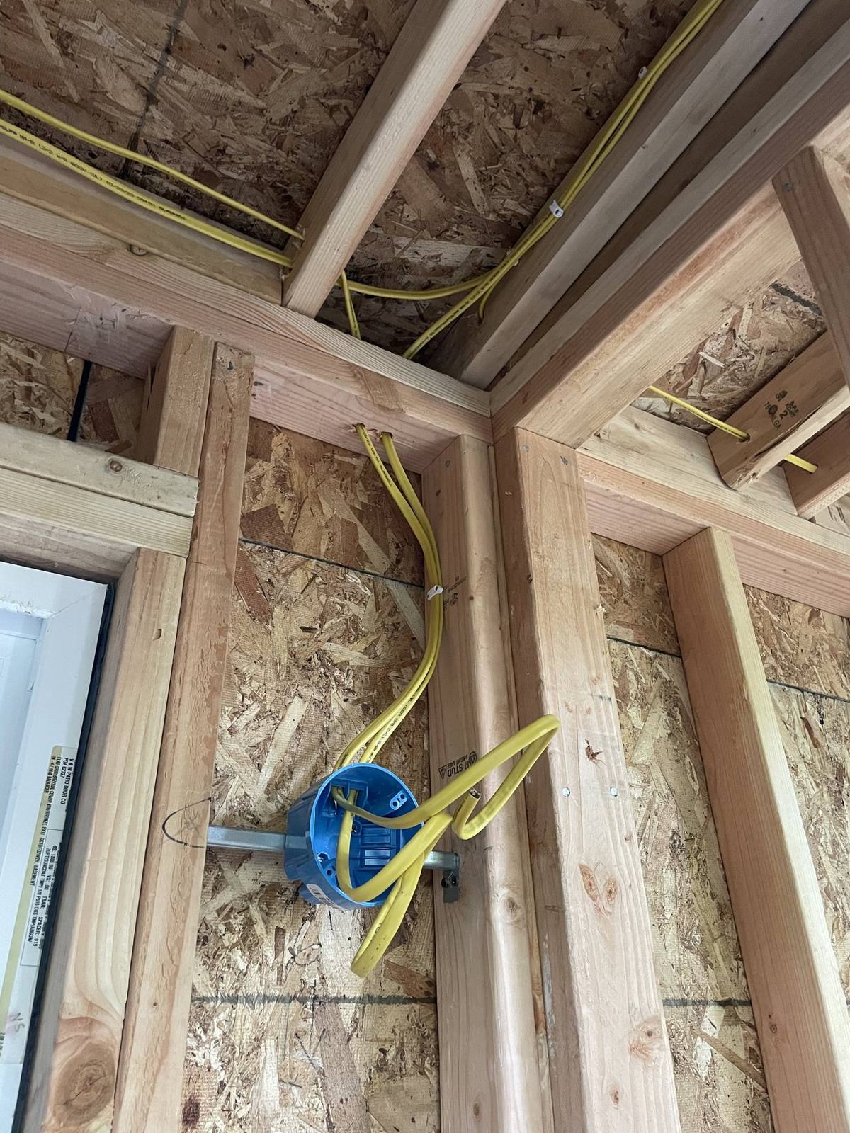 Wiring roughed in around a new window opening in framed wall