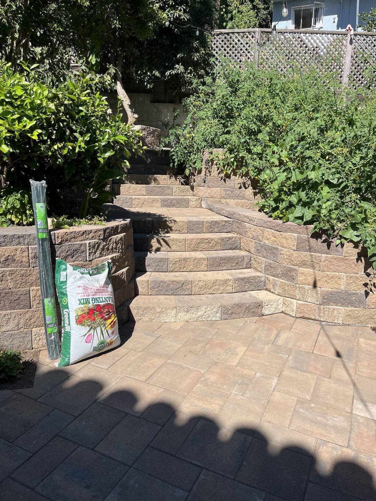 Terraced backyard with paver steps, retaining walls and planting