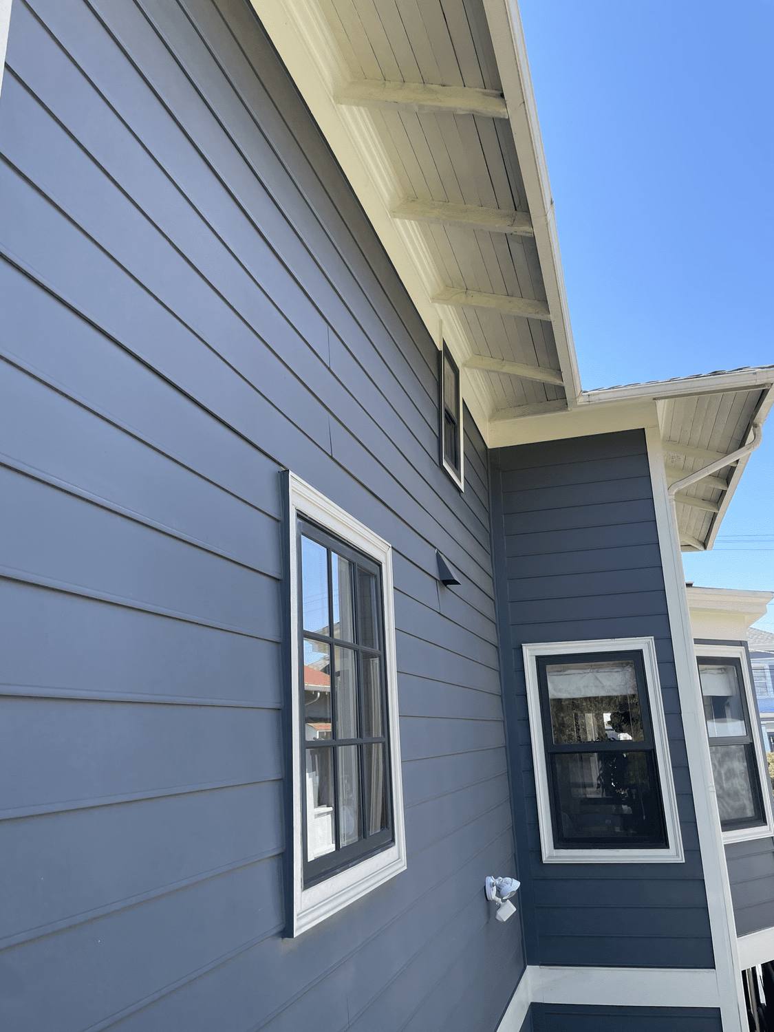 House exterior in deep gray with crisp white window casings