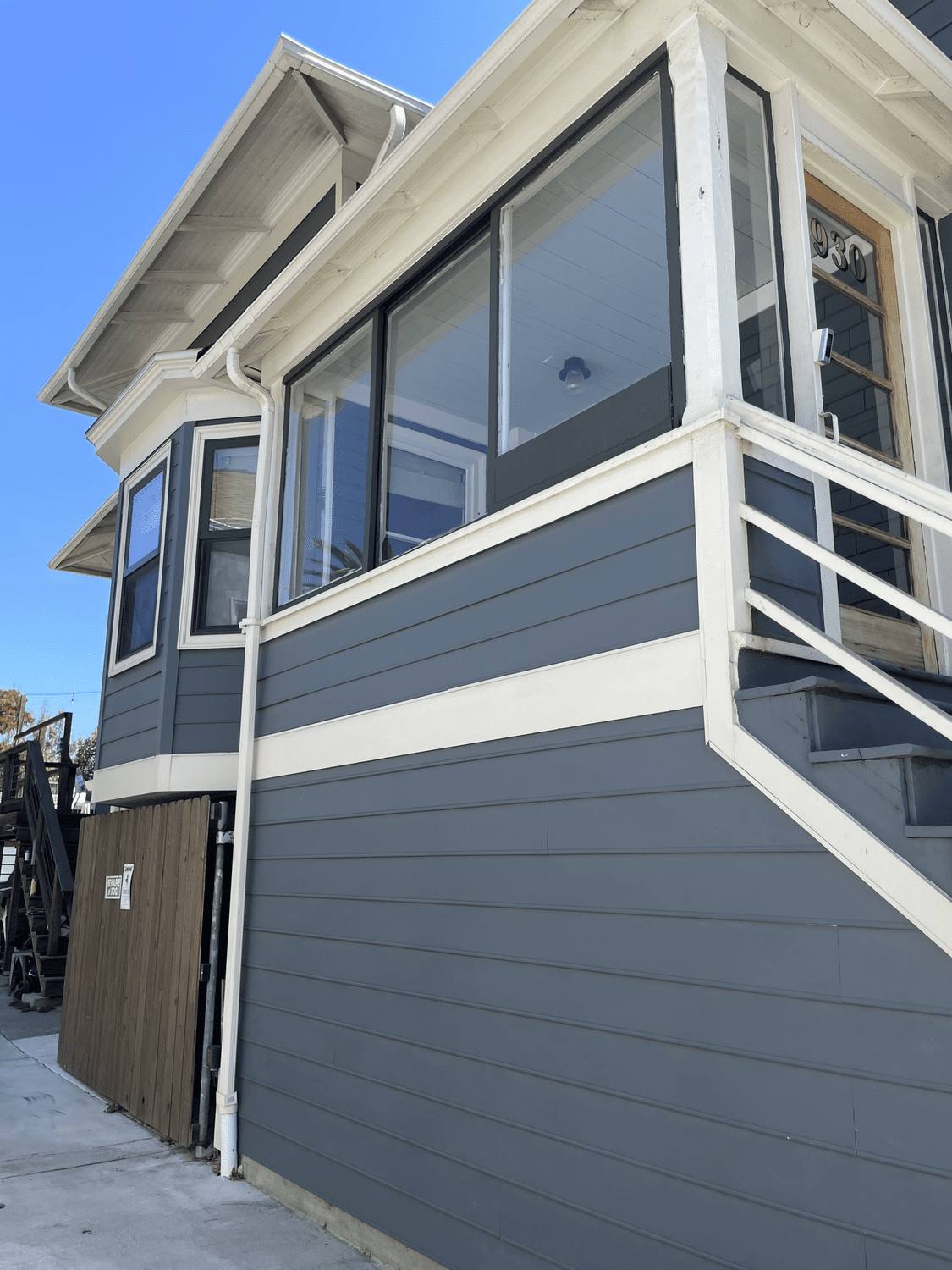 Upper story exterior with repainted siding, railing and window trim