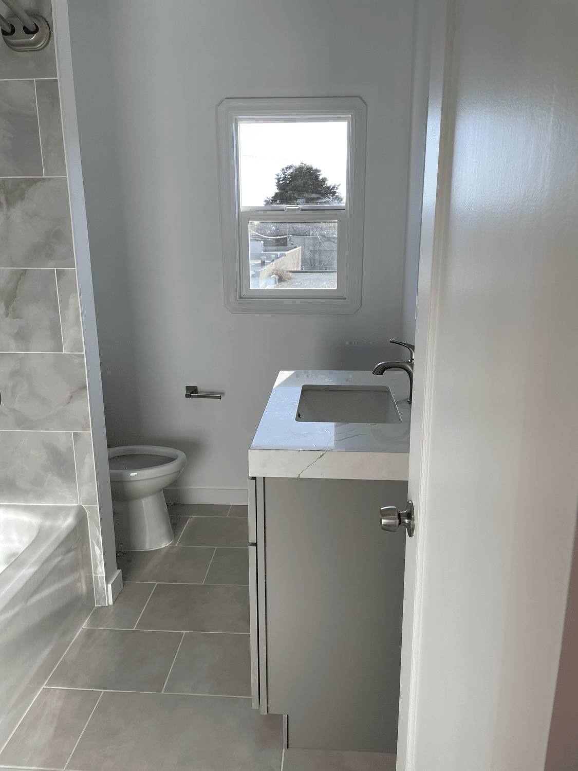 Bathroom with new tile flooring and vanity